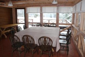 a dining room with a table and chairs at Aido ir Vido sodyba in Utena