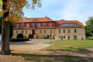 ein großes Backsteinhaus mit rotem Dach in der Unterkunft Schloss Zehdenick in Zehdenick