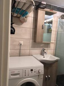 a bathroom with a washing machine and a sink at 30 Amynta in Katerini