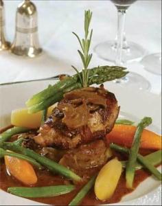 a plate of food with meat and vegetables on a table at Winter Clove Family Inn in Round Top