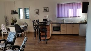 a kitchen with a sink and a table and chairs at Apartments Elda in Makarska