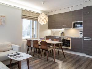 a kitchen and living room with a table and chairs at Holiday Home Tahko spa red - vuori apartment by Interhome in Tahkovuori