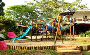 a playground in front of a house with a slide at Finca El Jecho in Villavicencio