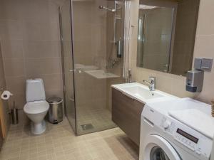 a bathroom with a toilet sink and a shower at Holiday Home Tahko spa red - golf apartment by Interhome in Tahkovuori