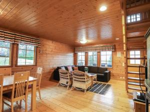 een woonkamer met een bank en een tafel en stoelen bij Holiday Home Dominus by Interhome in Böle