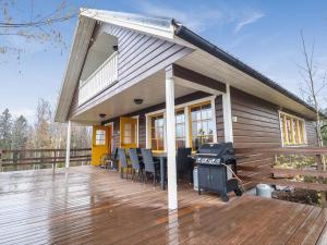 a house with a grill on a wooden deck at Holiday Home Dominus by Interhome in Böle