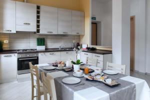 a kitchen with a table with plates and food on it at Rome Central Rooms in Rome