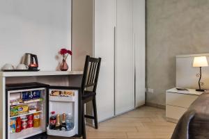 a kitchen with a chair and a small refrigerator at Rome Central Rooms in Rome