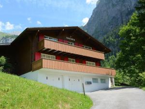 a building with a balcony on the side of a hill at Apartment Chalet Heureka-Horbis by Interhome in Engelberg