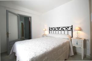 1 dormitorio con cama blanca y espejo en Casa Carretas SpainSunRentals 1050, en Nerja