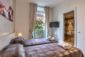 a bedroom with a large bed and a window at Rome Central Rooms in Rome