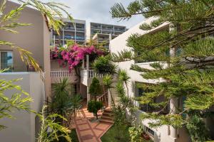 an internal courtyard of a building with plants and flowers at Elotis Suites in Agia Marina Nea Kydonias