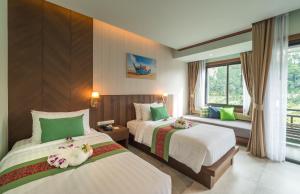 Postel nebo postele na pokoji v ubytování Andaman Breeze Resort