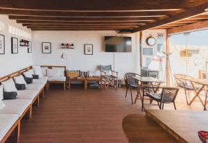 a living room with couches and tables and a tv at Lagos Uptown Bed & Breakfast in Lagos