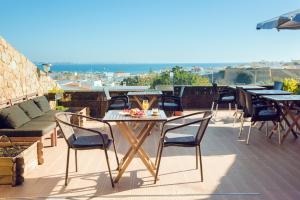 a patio with tables and chairs on a roof at Lagos Uptown Bed & Breakfast in Lagos