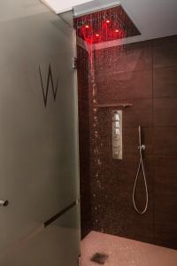 a bathroom with a shower with red lights in it at White Angel Hotel in Breuil-Cervinia