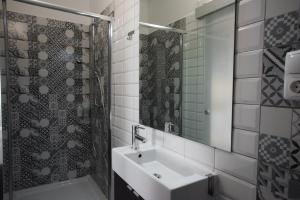 a bathroom with a sink and a shower at Lagos Uptown Bed & Breakfast in Lagos +47 photos