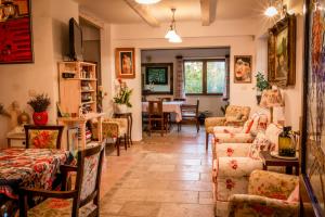 a living room with couches and a dining room at Daiconi Boutique House in Miniş