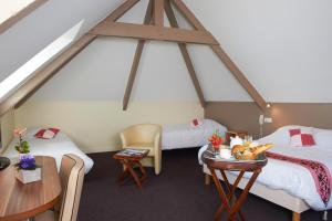 A bed or beds in a room at Logis Hotel Belle-Vue
