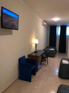 a living room with a tv on the wall at Hotel Chopin in Fiumicino