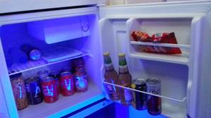 an open refrigerator filled with lots of drinks and soda at SLEEPBOAT Barco Hotel Oporto Douro in Porto