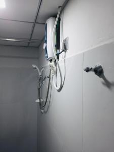 a shower head on the wall of a bathroom at Malee Homestay in Polonnaruwa