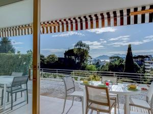 a dining room with a table and chairs on a balcony at Apartment Les Hortensias by Interhome in Cannes