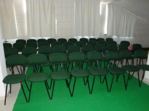 a group of green chairs sitting in a room at Pereira Guesthouse Cecilia Inn in Fátima