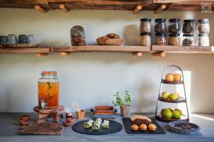 a table with plates of food on it with shelves at Zuri Zanzibar in Kendwa