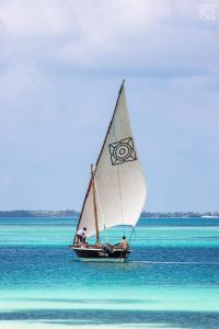 a group of people on a sail boat on the water at Zuri Zanzibar in Kendwa