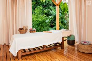 a bed in a room with a large window at Zuri Zanzibar in Kendwa