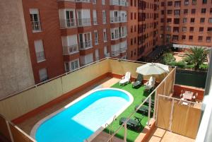 an overhead view of a swimming pool on the roof of a building at ARGANZUELA in Madrid