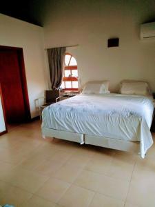 a bedroom with a white bed and a window at Simpson Bay Yatch Club 2 Bedrooms in Simpson Bay