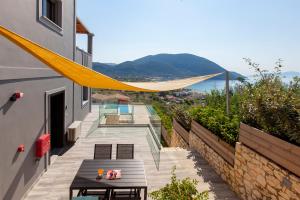 a balcony with a table and a view of the ocean at Drakatos Villas in Vasiliki