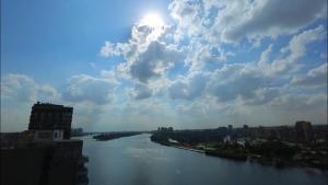 a view of a river with the sun in the sky at Arabia Hotel in Cairo
