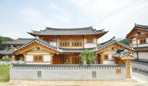 a building with a chinese roof at Chaehyodang Hanok Stay in Seoul