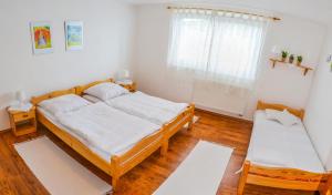 A bed or beds in a room at Penzión Gardoš