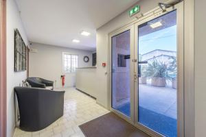 an office with a door leading into a hallway at Hôtel du Rocher in Marseille