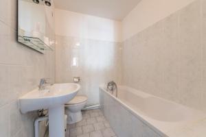 een badkamer met een wastafel, een toilet en een bad bij Hôtel du Rocher in Marseille