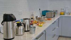 a kitchen with a counter top and a cupboard at Topcity Hostel & Suites in Lagos