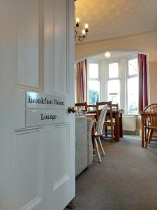 a kitchen and dining room with a couch and a table at Rutland West Guest House in Filey
