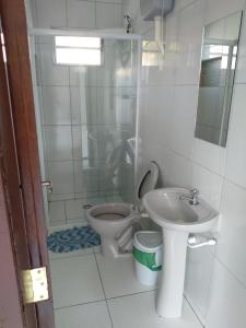 a bathroom with a toilet and a sink at Casa na praia in Itapoa