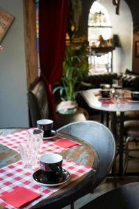 a table with a red and white checkered table cloth at Hôtel Le G (ex Le Genève) in Nice