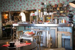 a kitchen with a table with a bowl of fruit at Hôtel Le G (ex Le Genève) in Nice