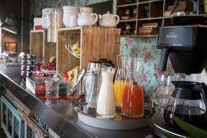 a counter with some bottles and glasses of juice at Hôtel Le G (ex Le Genève) in Nice