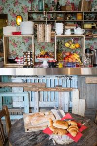 a kitchen with a table with bread on it at Hôtel Le G (ex Le Genève) in Nice