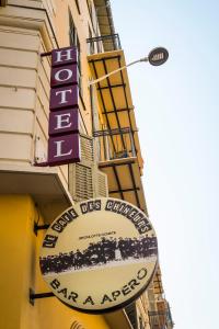 a sign for a restaurant on the side of a building at Hôtel Le G (ex Le Genève) in Nice