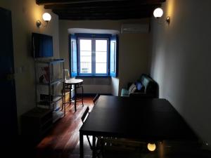 a living room with a table and a window at Alfama Fado Apartments in Lisbon