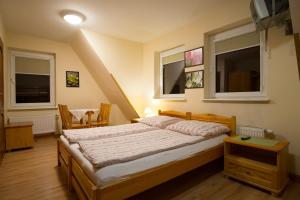 a bedroom with a bed and two windows at Pohulanka in Zakopane