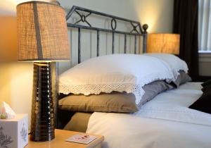 a bed with two pillows and a lamp on a table at The Villa Bridlington in Bridlington